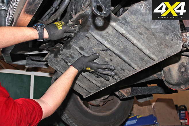 14 Reattach bash plate and remove vehicle safety stand
