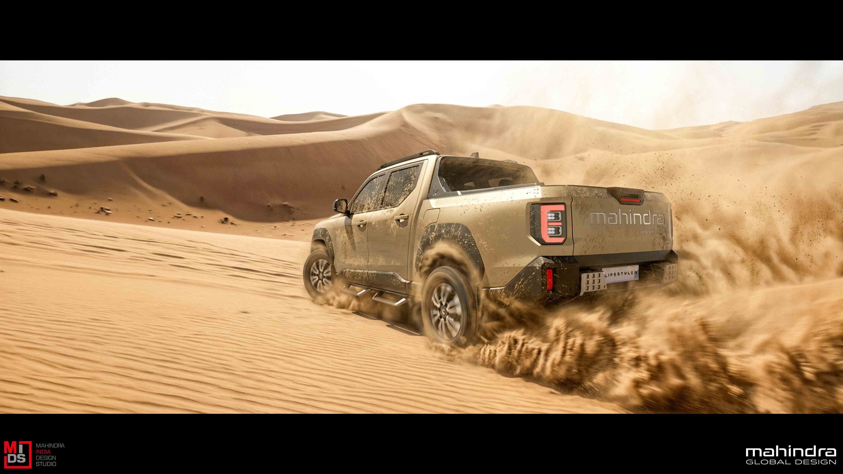 Pickup truck driving through a sandy desert, dust clouds and tall dunes in the background, vehicle kicking up sand while speeding sideways across the terrain, Mahindra branding visible on the tailgate.