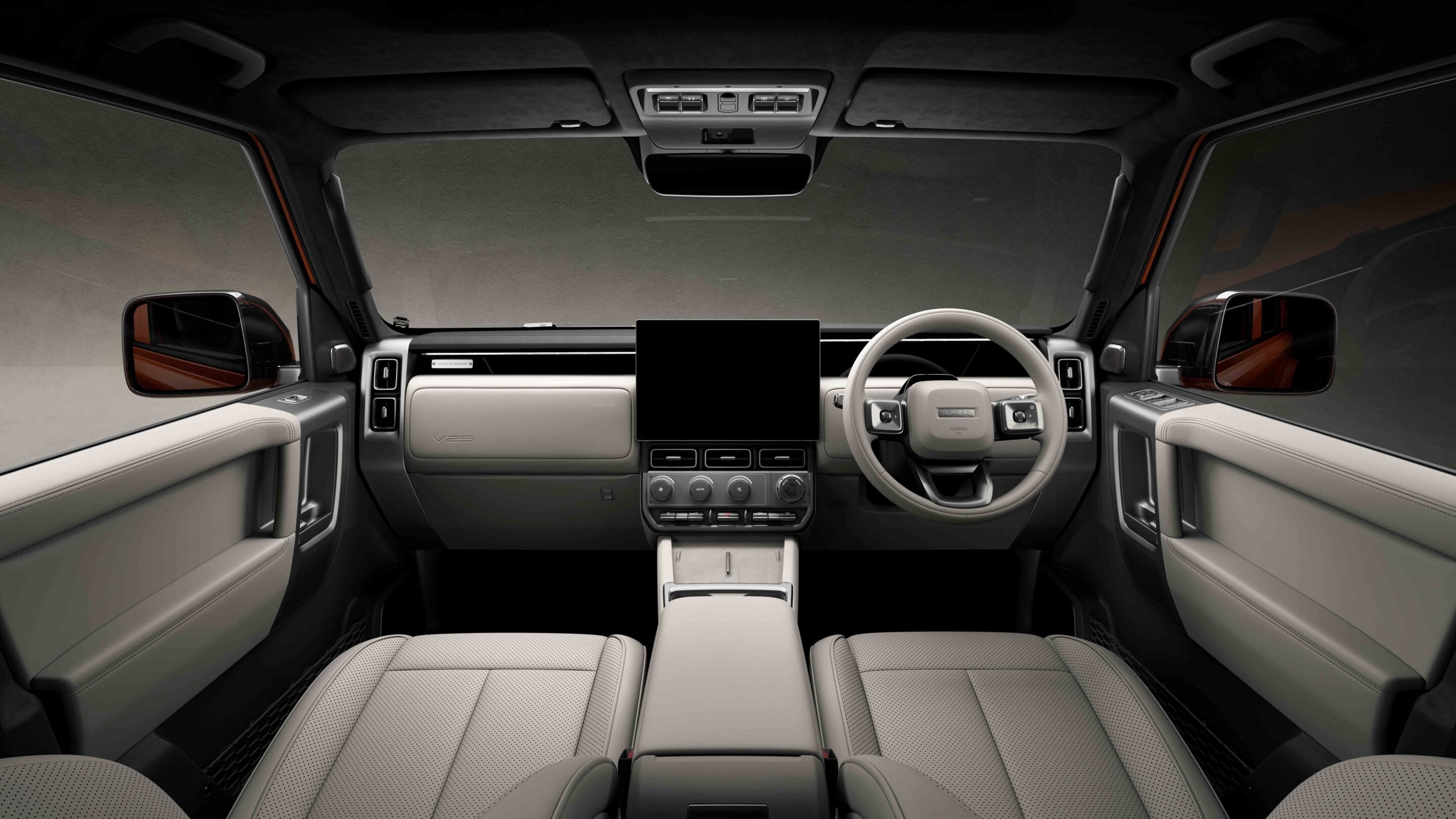 Front interior of a luxury SUV from the back-seat perspective, featuring a large central touchscreen and beige leather seats