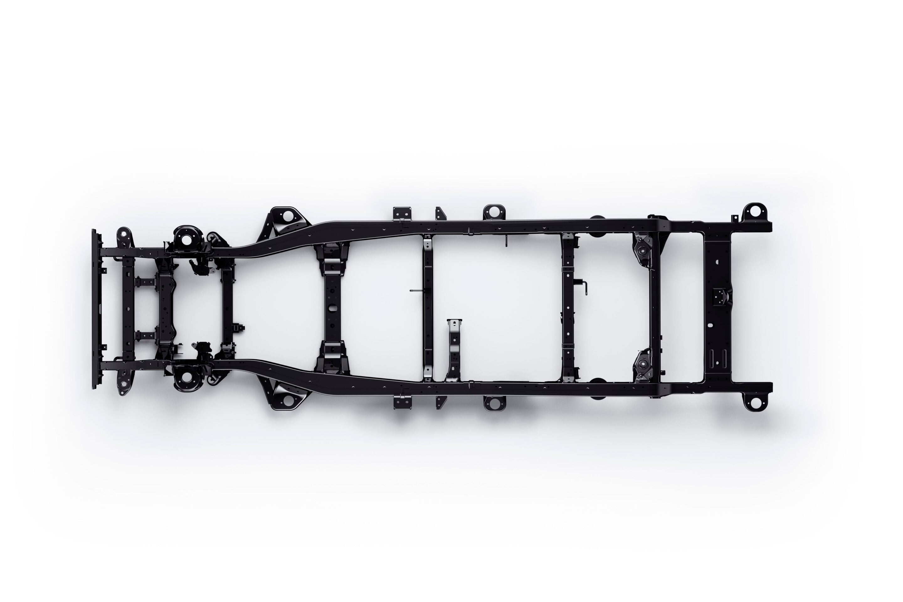 Underside view of a black automobile chassis frame with crossmembers and mounting points against a white background.