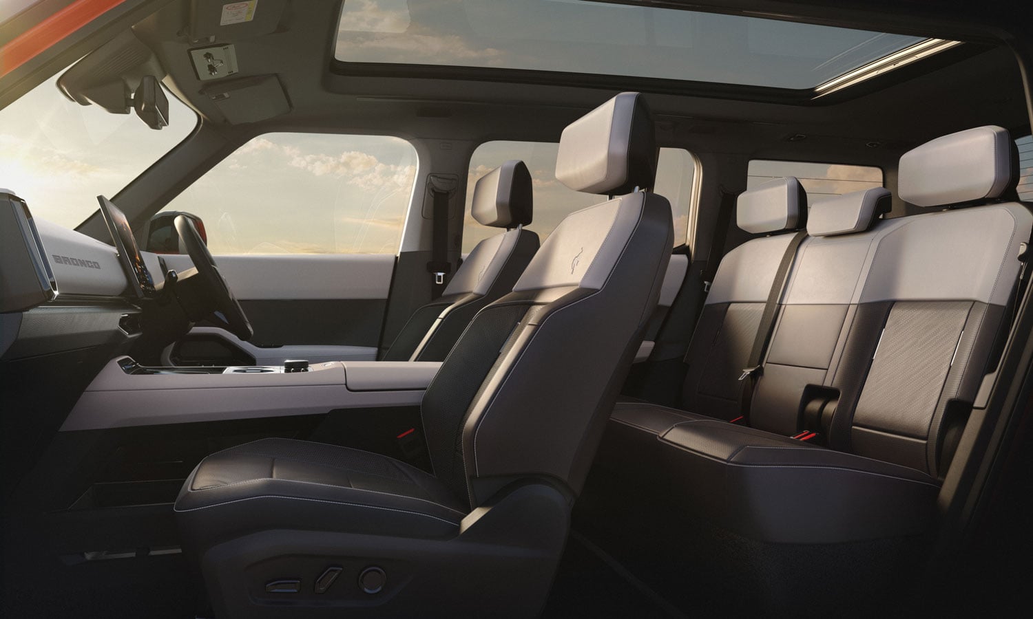 Luxurious SUV interior with two front bucket seats, center console, and a rear bench under a panoramic sunroof.