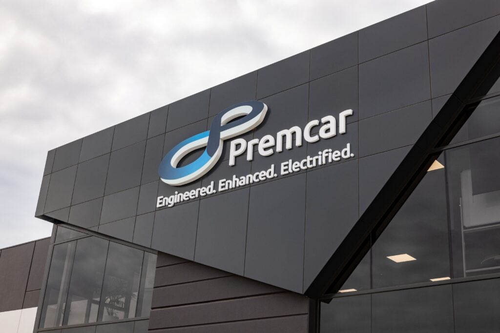 Modern building exterior with Premcar logo and the slogan 'Engineered. Enhanced. Electrified.'