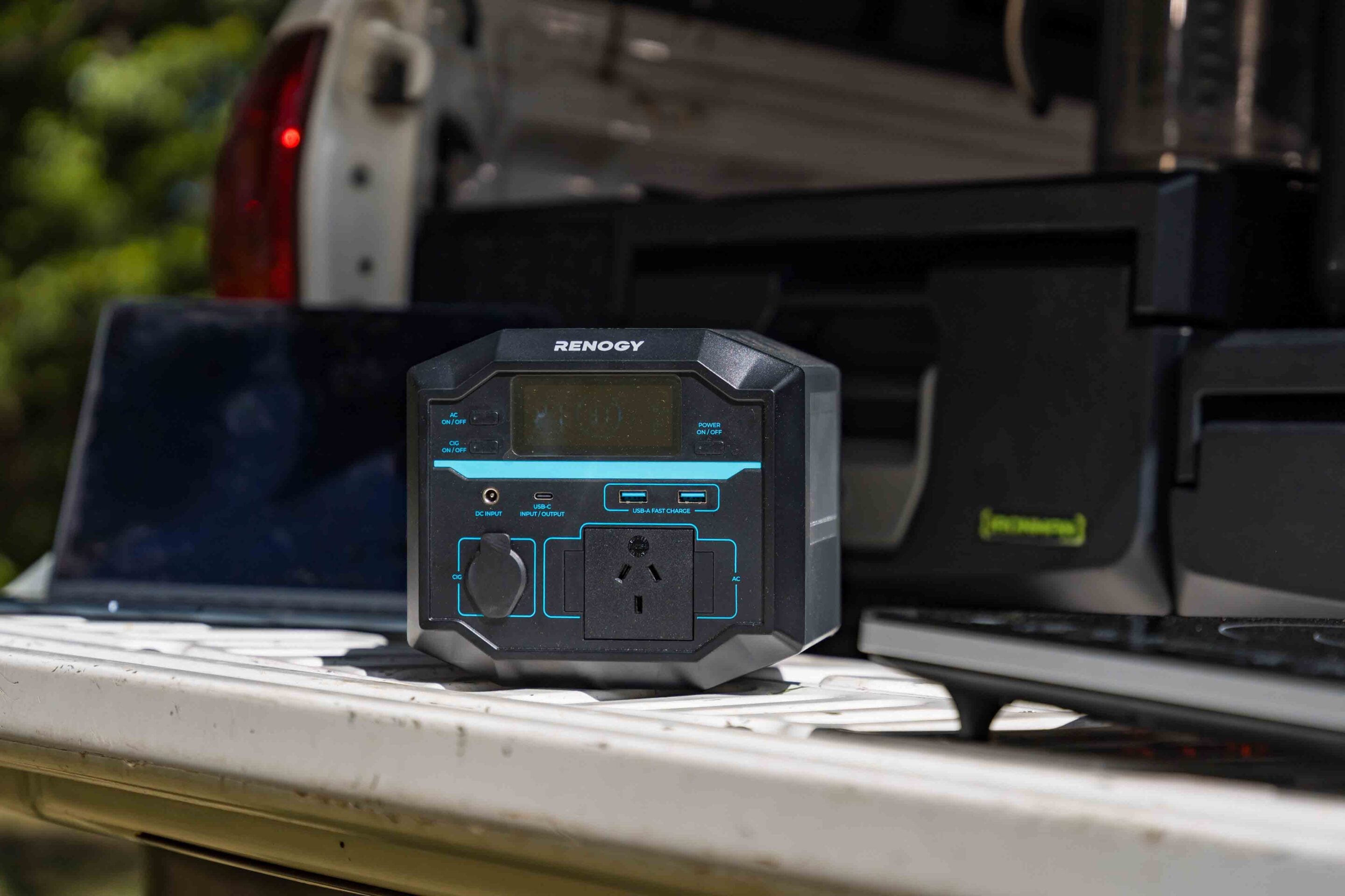 Renogy portable power station resting on a truck bed tailgate outdoors.