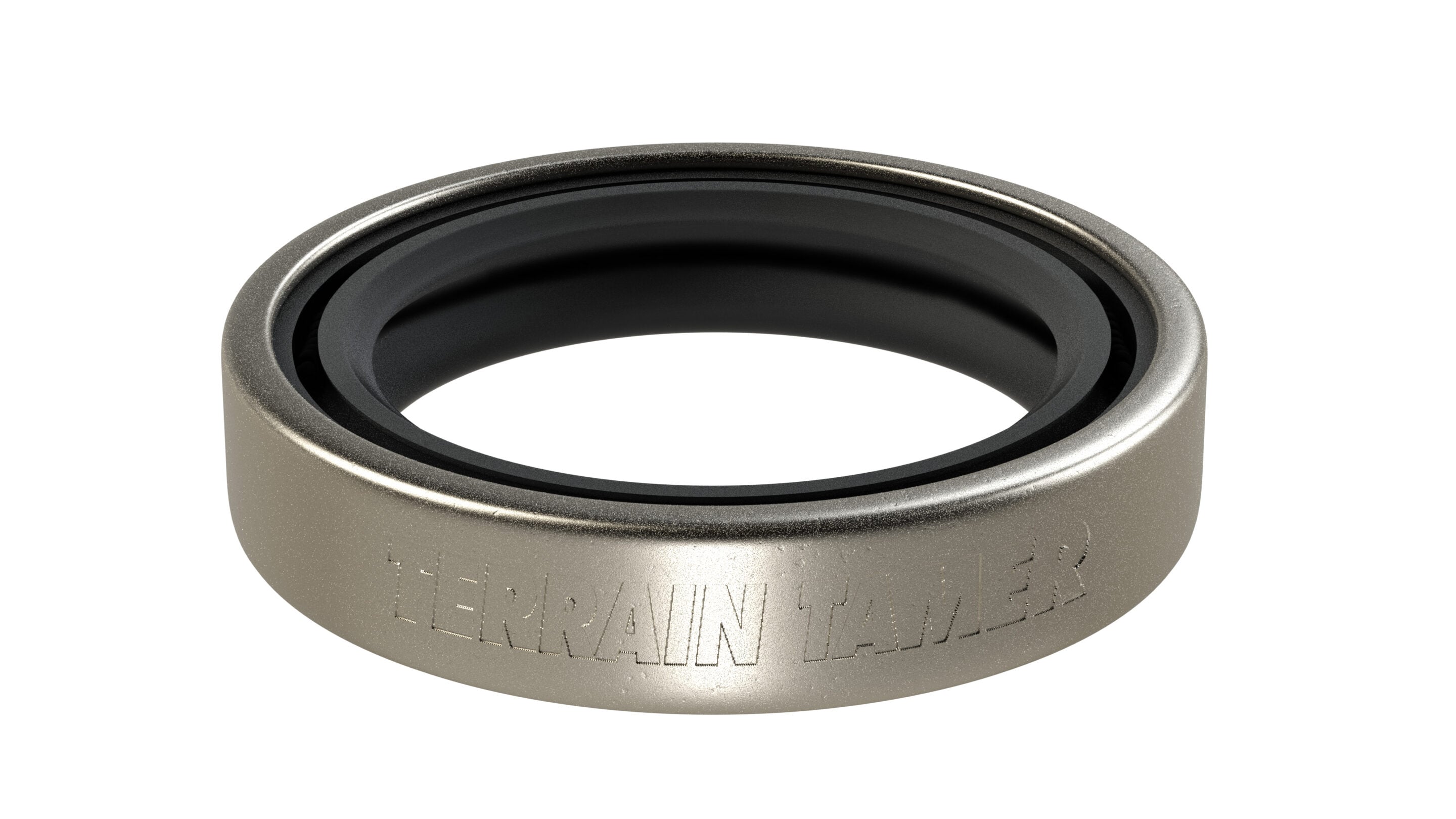 Close-up of a metallic circular ring with a black inner bore and faint engraved text along the outer rim.