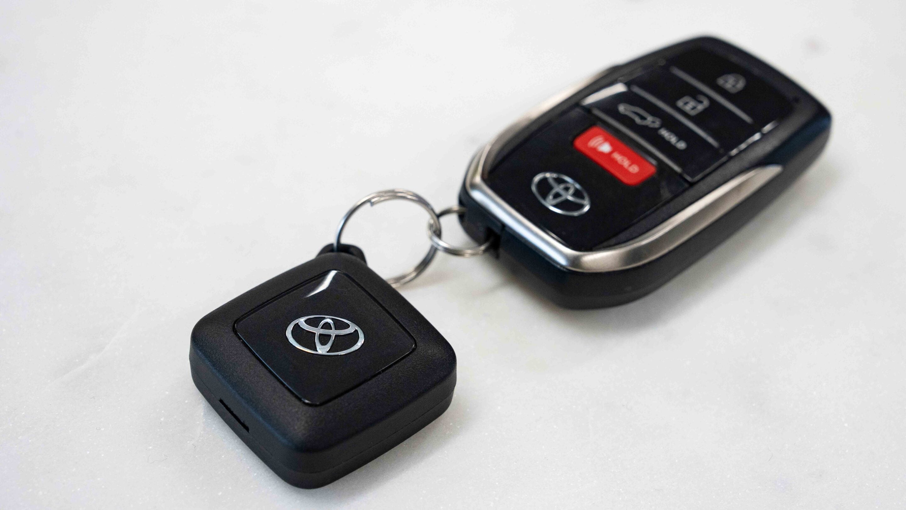 Toyota car key fobs on a metal key ring with the Toyota logo visible on each fob