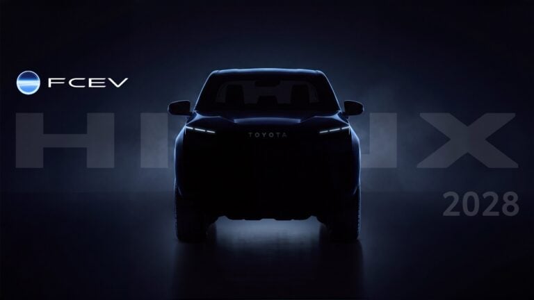 Futuristic Toyota electric vehicle seen from the rear against a dark blue backdrop with the FCEV logo on the left and '2028' in the corner.