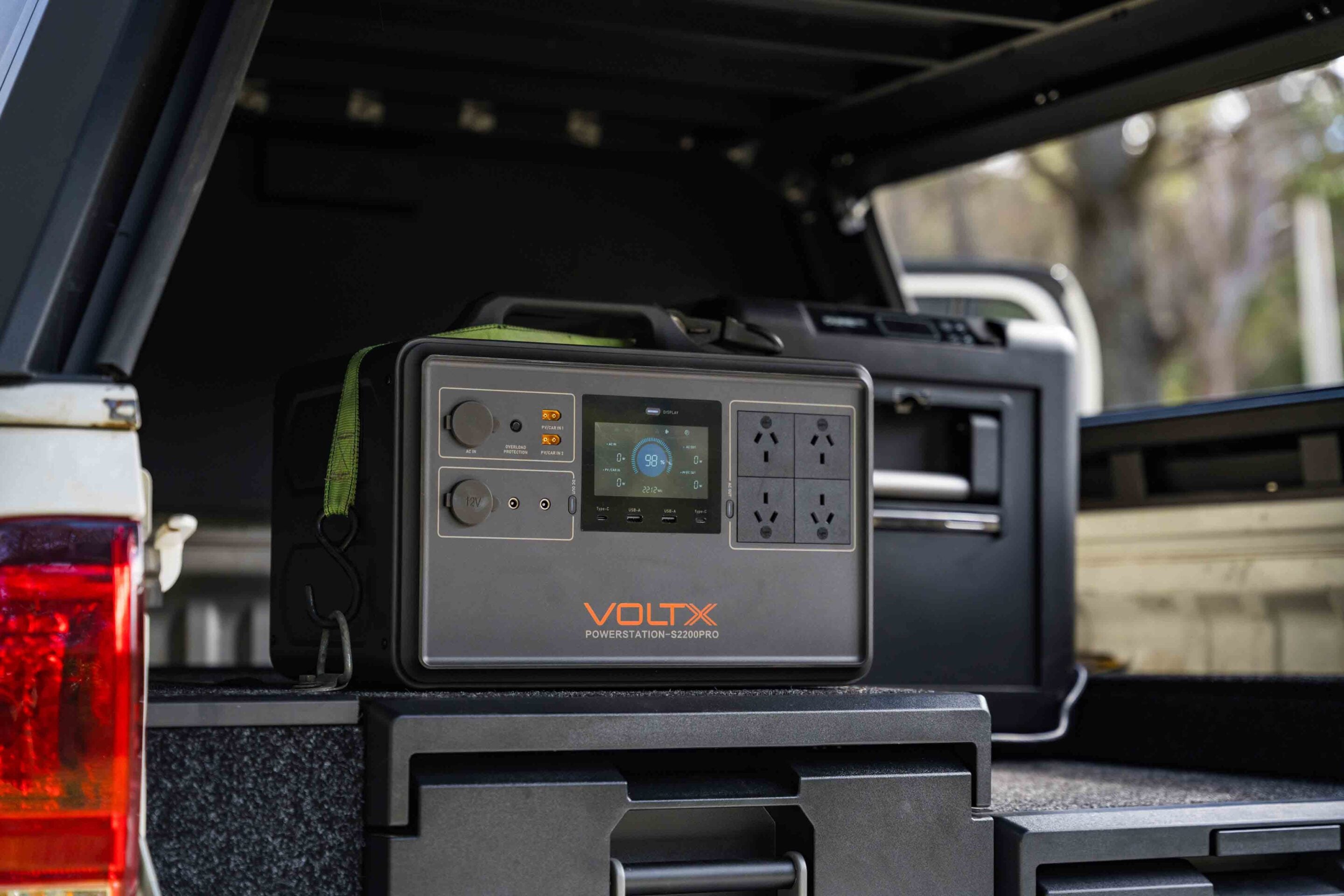 VoltX Power Station S2200PRO in the open truck bed tailgate area, showing outlets and display panel
