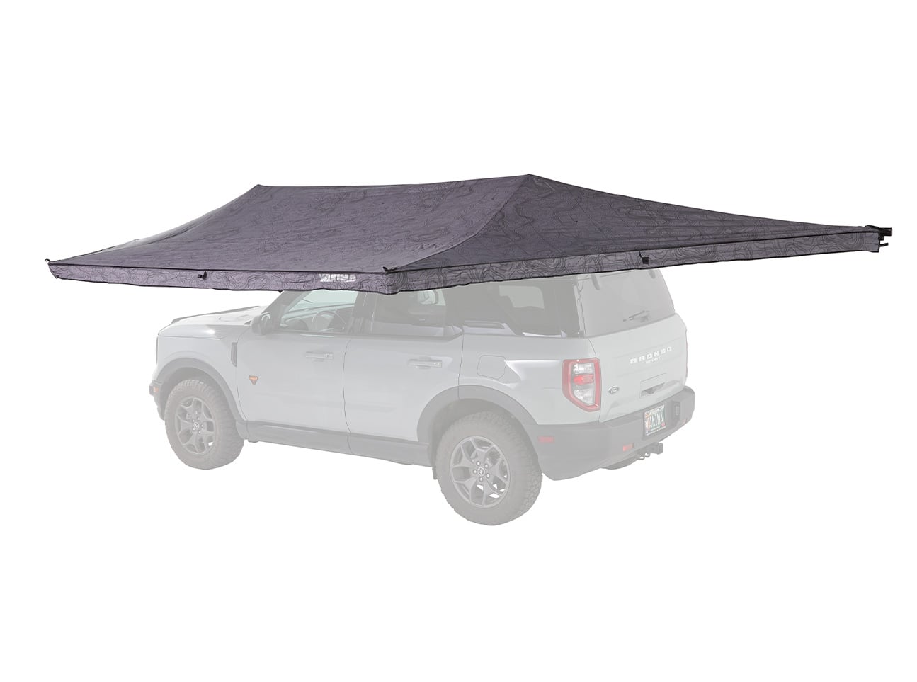 White SUV with a large dark gray rooftop tent extended over the roof.