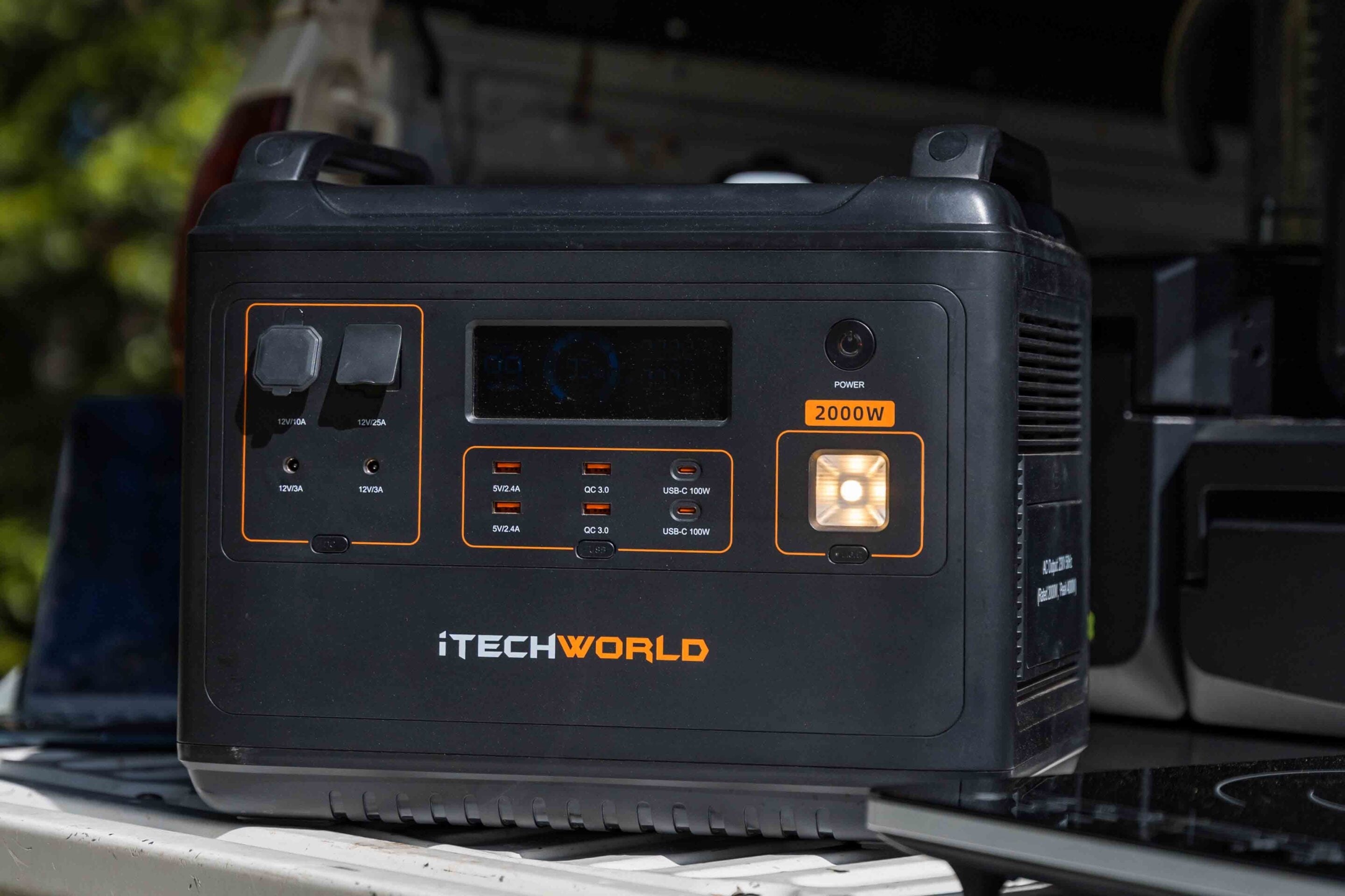Portable power station with multiple USB and AC ports, brand name iTECHWORLD, 2000W label on front panel, lit display and power button visible