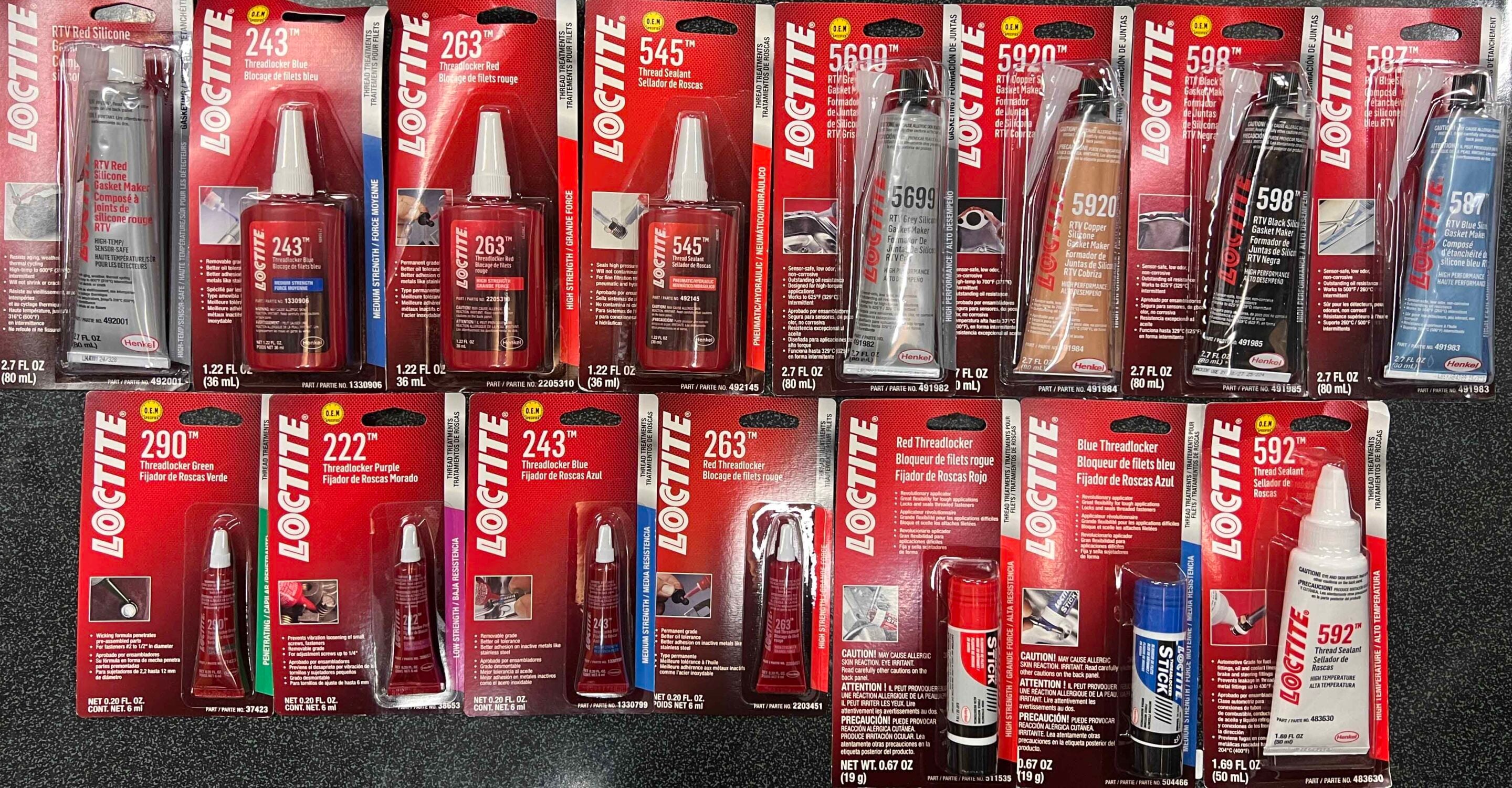 Row of Loctite adhesive products in red packaging on a store shelf, showing bottles and tubes with product numbers.