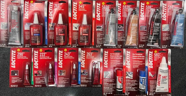 Row of Loctite adhesive products in red packaging on a store shelf, showing bottles and tubes with product numbers.